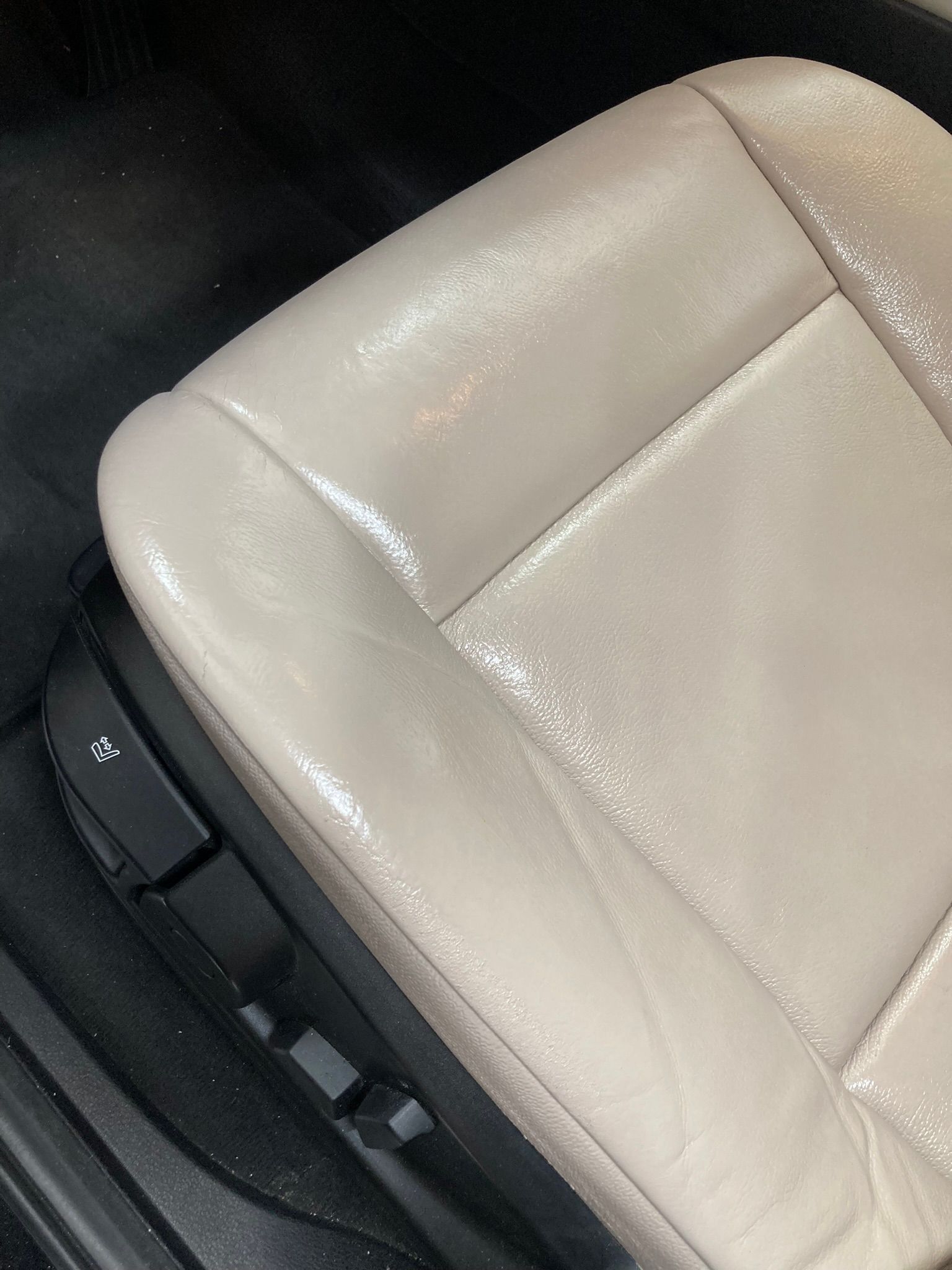 Un primer plano de un asiento de cuero blanco en un automóvil.
