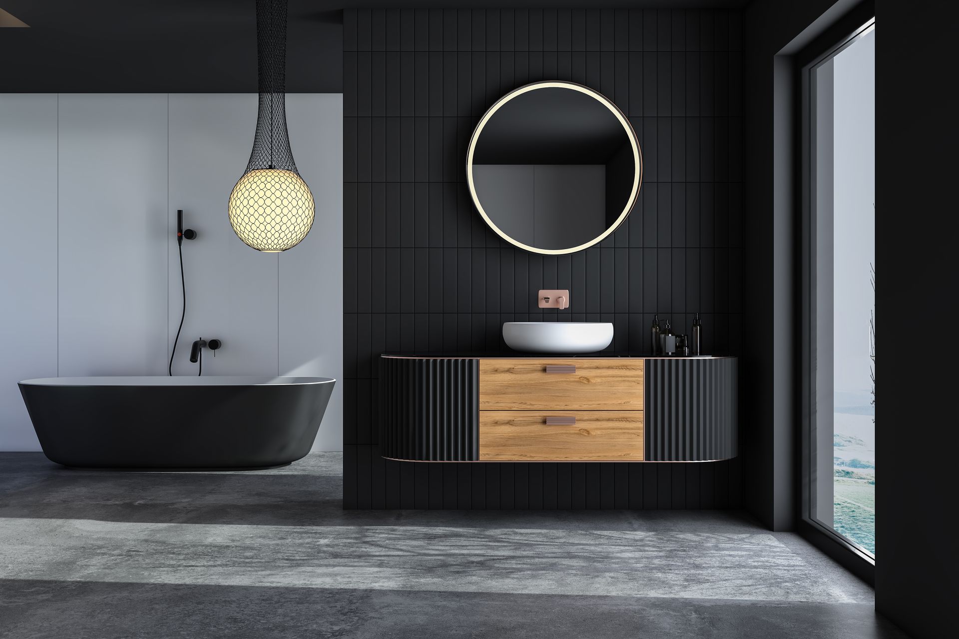 Salle de bains moderne avec des touches de noir : baignoire, meuble lavabo et miroir rond.
