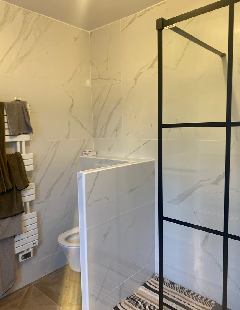 Salle de bains rénovée avec cloison vitrée et douche à l’italienne