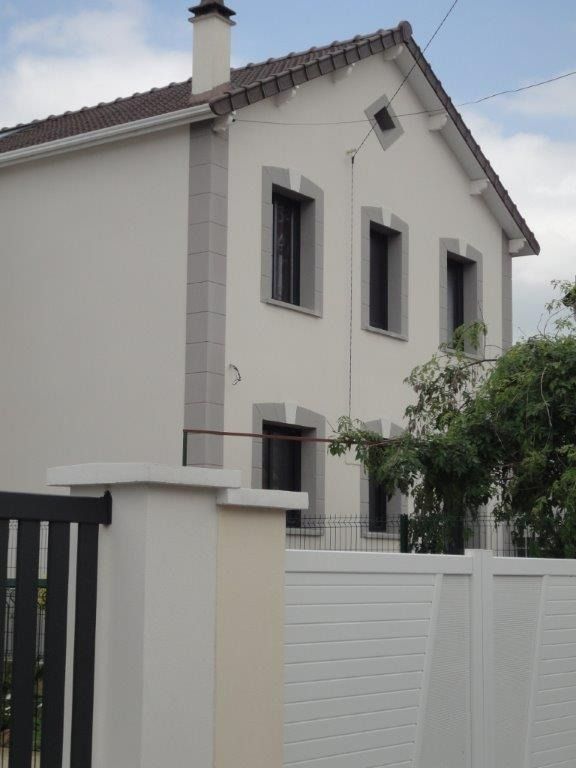Façade rénovée d’une maison des années 20 avec un enduit clair