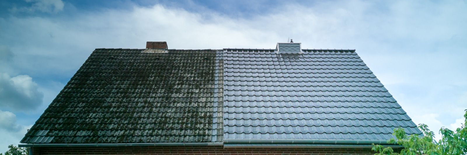 Two rooftops under a cloudy blue sky, one dark green and one light gray