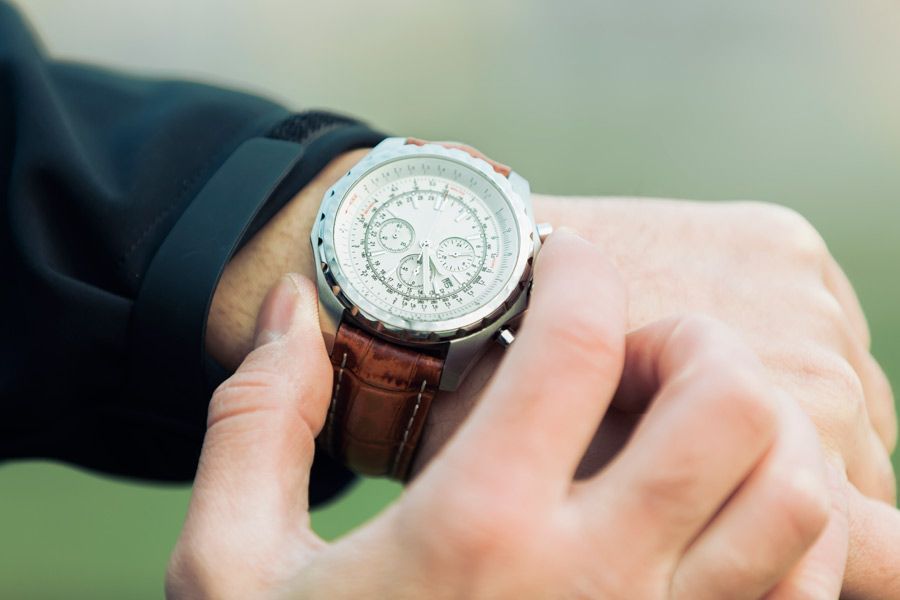 Un hombre mira su reloj en su muñeca.