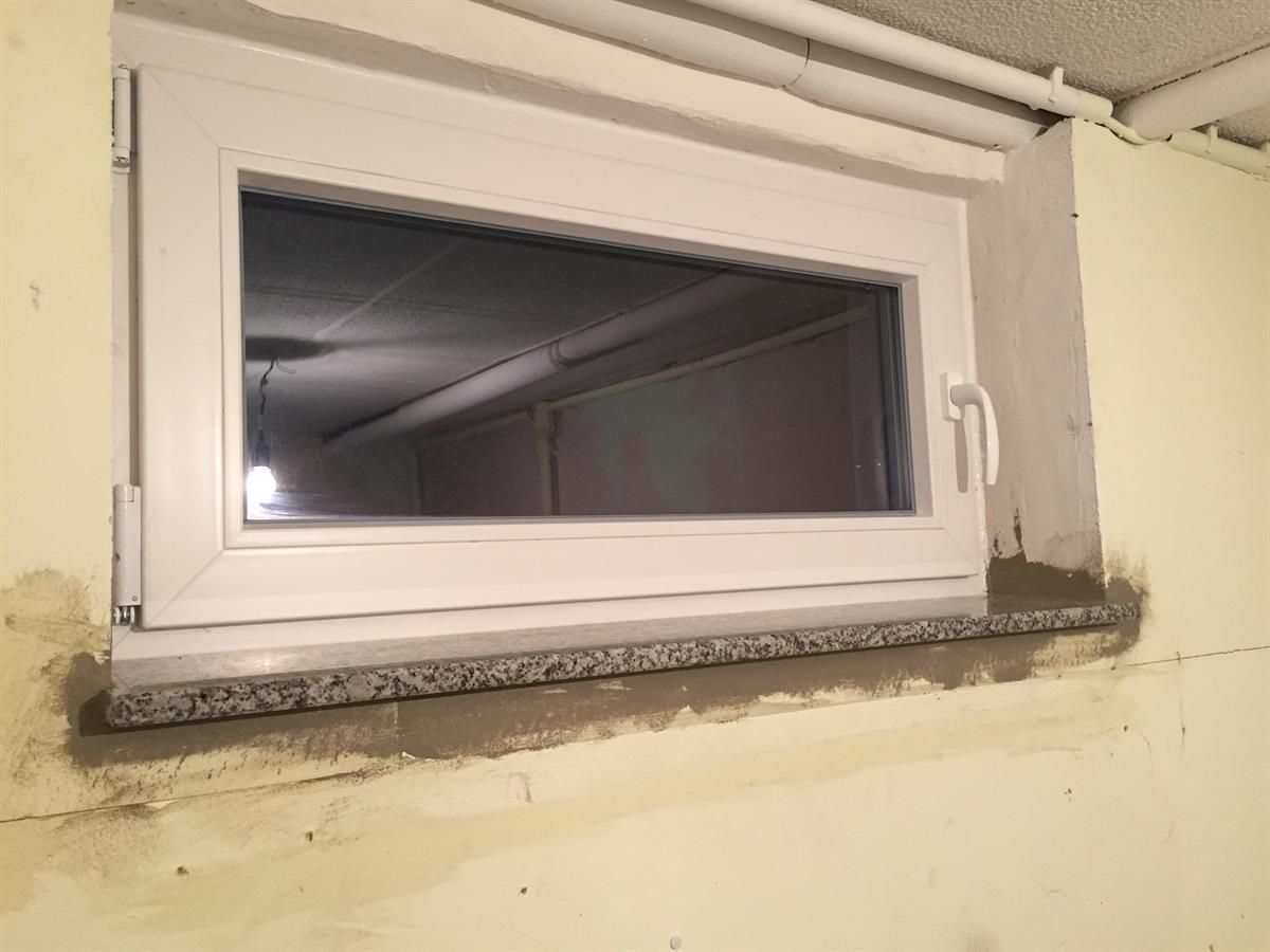 In eine Wand wird ein weißes Fenster eingebaut.