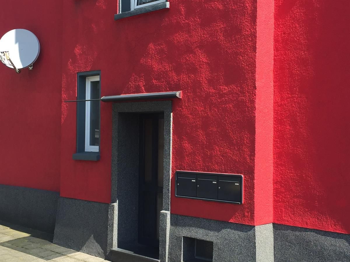 Ein rotes Gebäude mit einer Satellitenschüssel darauf