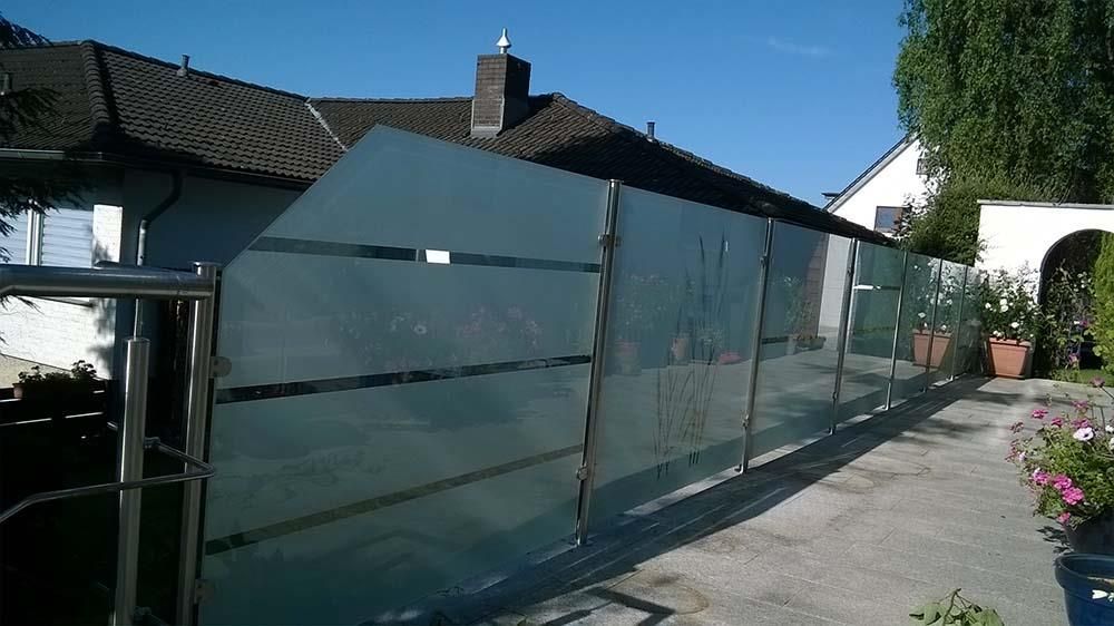 Ein Haus mit einem Glaszaun davor