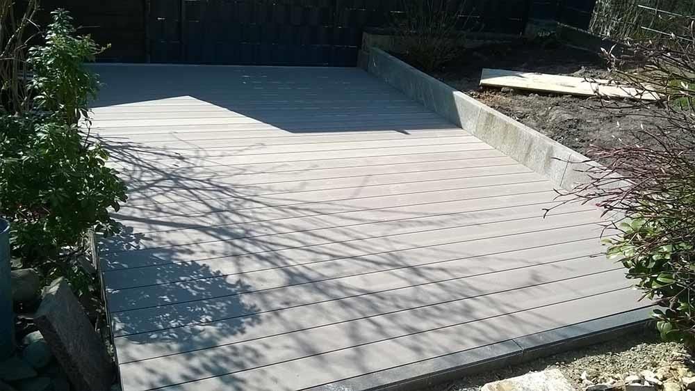 Ein Betonweg mit ein paar Bäumen im Hintergrund