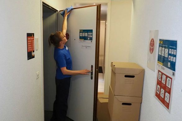 Mitarbeiterin von der superReinigung GmbH putzt eine Tür