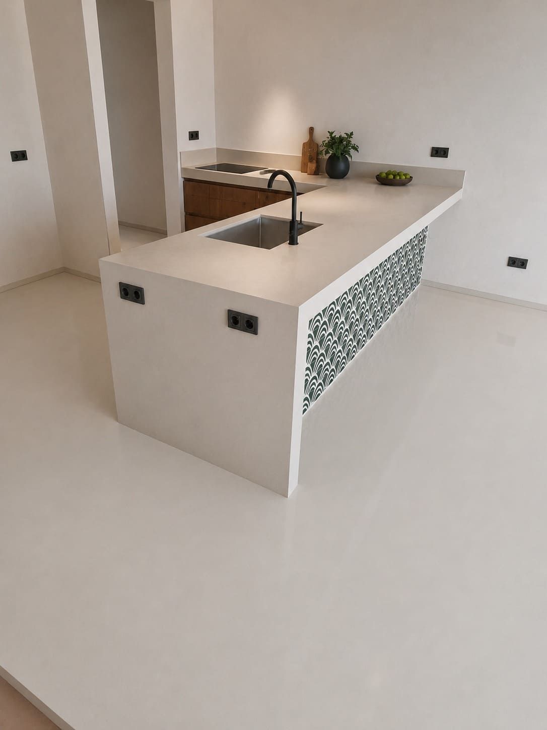 Isla de cocina moderna con encimeras blancas, fregadero integrado, detalles de azulejos de mosaico y plantas sobre la encimera.