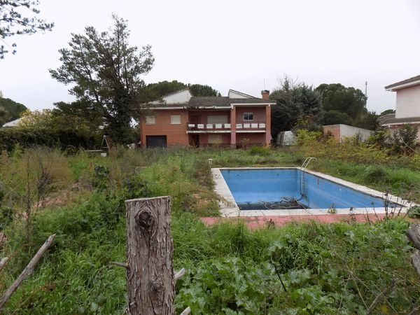Una piscina vacía frente a una casa
