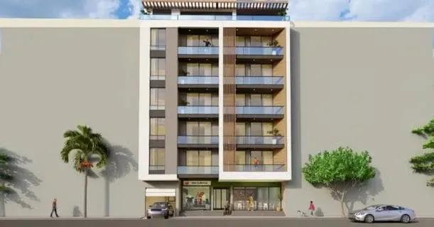 Fachada de prédio de apartamentos com varandas de vidro e espaço comercial no térreo. Pessoas e carros são visíveis na rua.