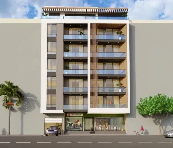 Edifício moderno de vários andares com lojas no térreo.