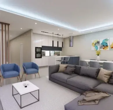 Modern living room with blue armchairs, gray sectional sofa, open kitchen, and dining area. White and gray color scheme.