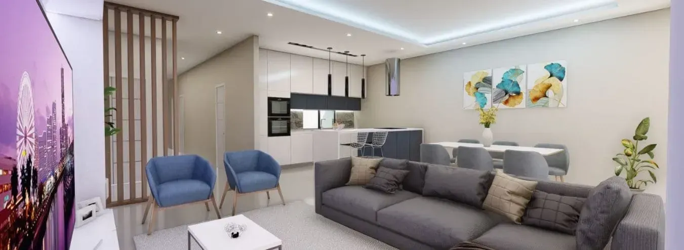 Sala de estar moderna com sofá secional cinza, poltronas azuis e cozinha americana com área de jantar. 