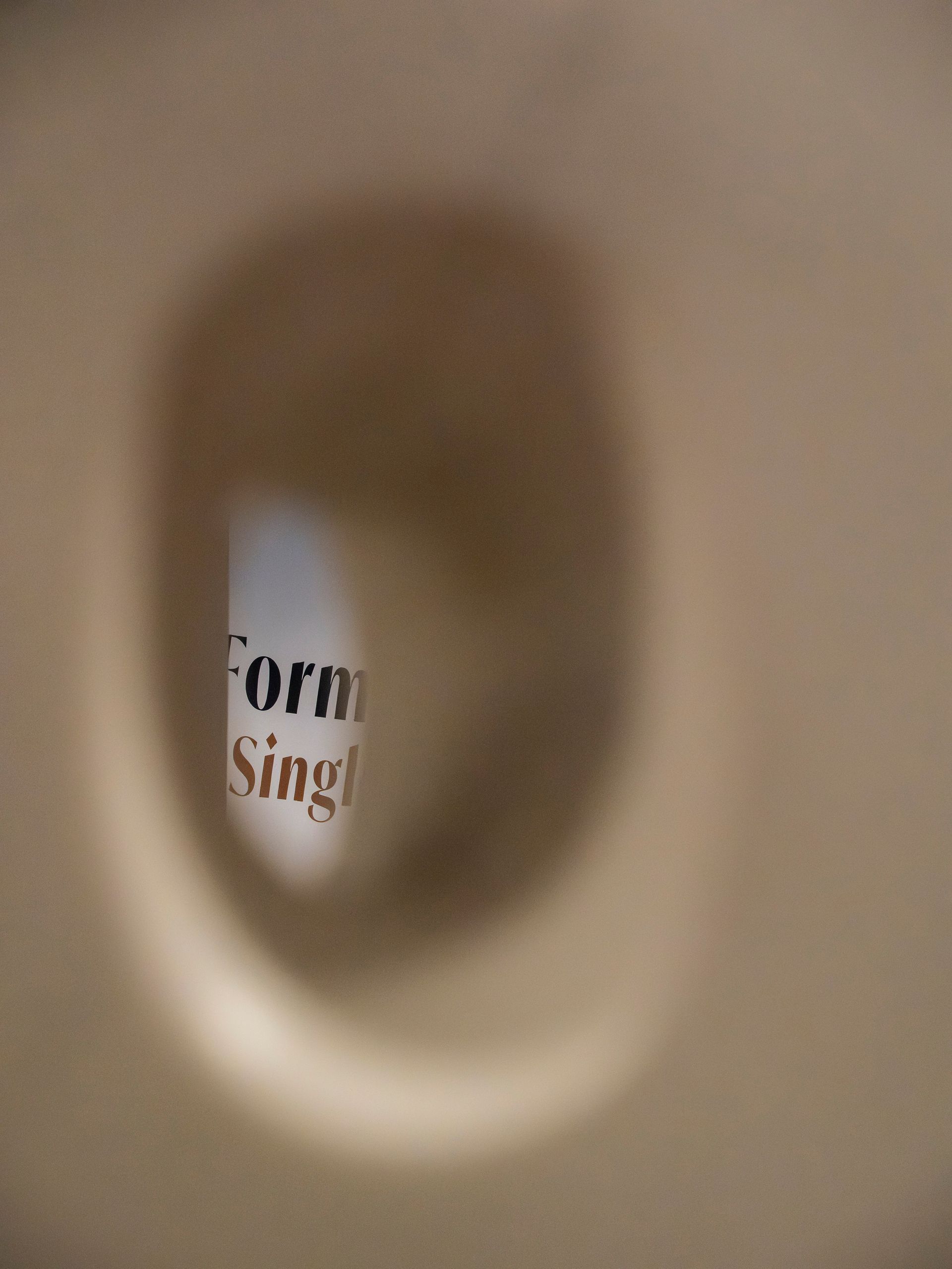 Blurred view through a hole; text fragment