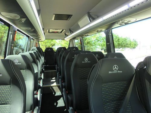 El interior de una furgoneta Mercedes-Benz con muchos asientos.