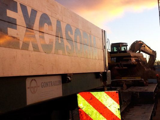 Vista de cerca de un remolque de construcción Excasoria con el logotipo de GONTRAILER y una señal de seguridad a rayas amarillas y rojas.