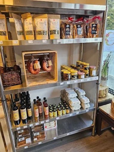 Étagère garnie de produits alimentaires : produits secs, saucisses, conserves, huiles et snacks.