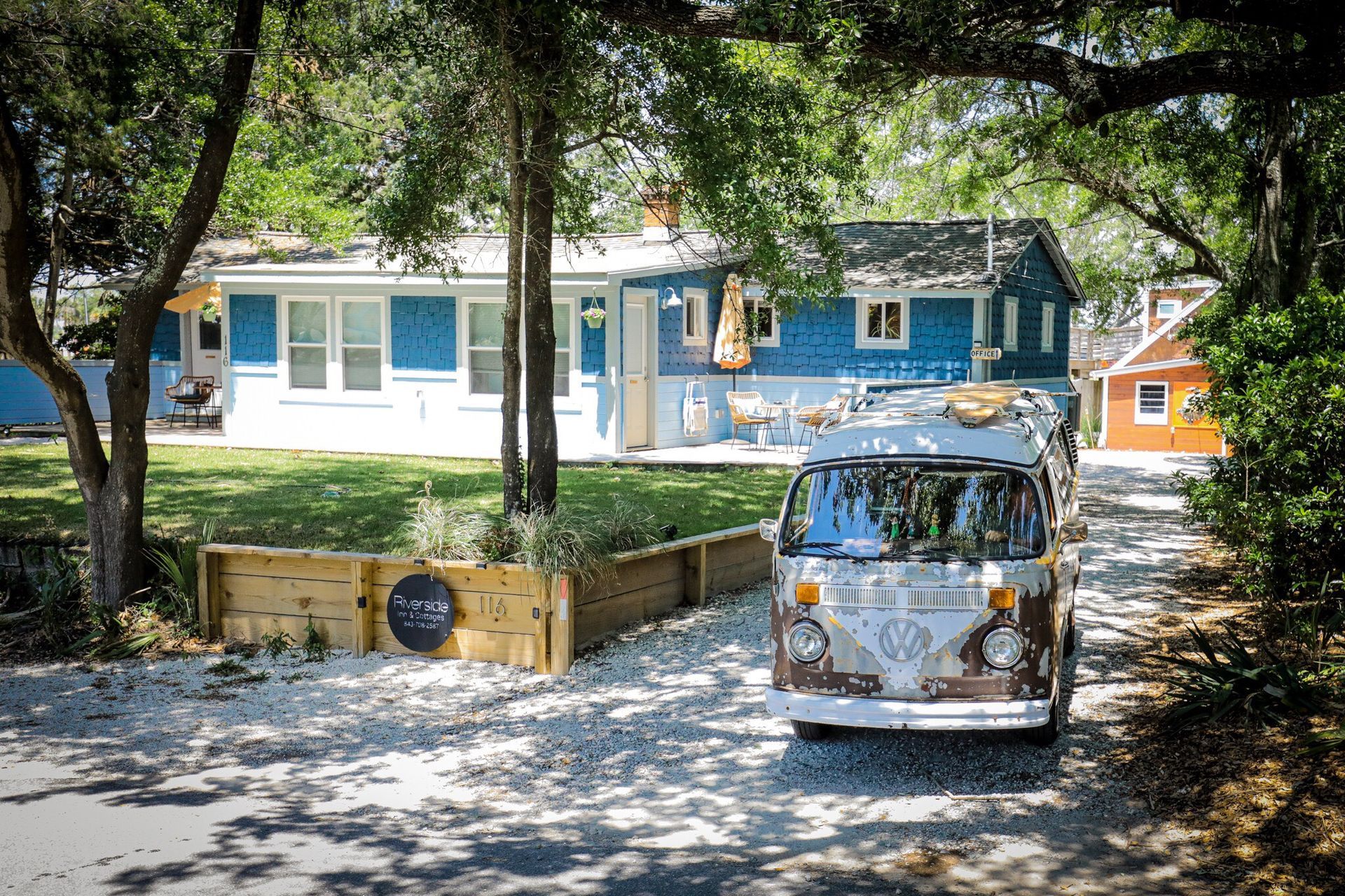 A room with a ceiling fan and a surfboard that says lifeguard on it