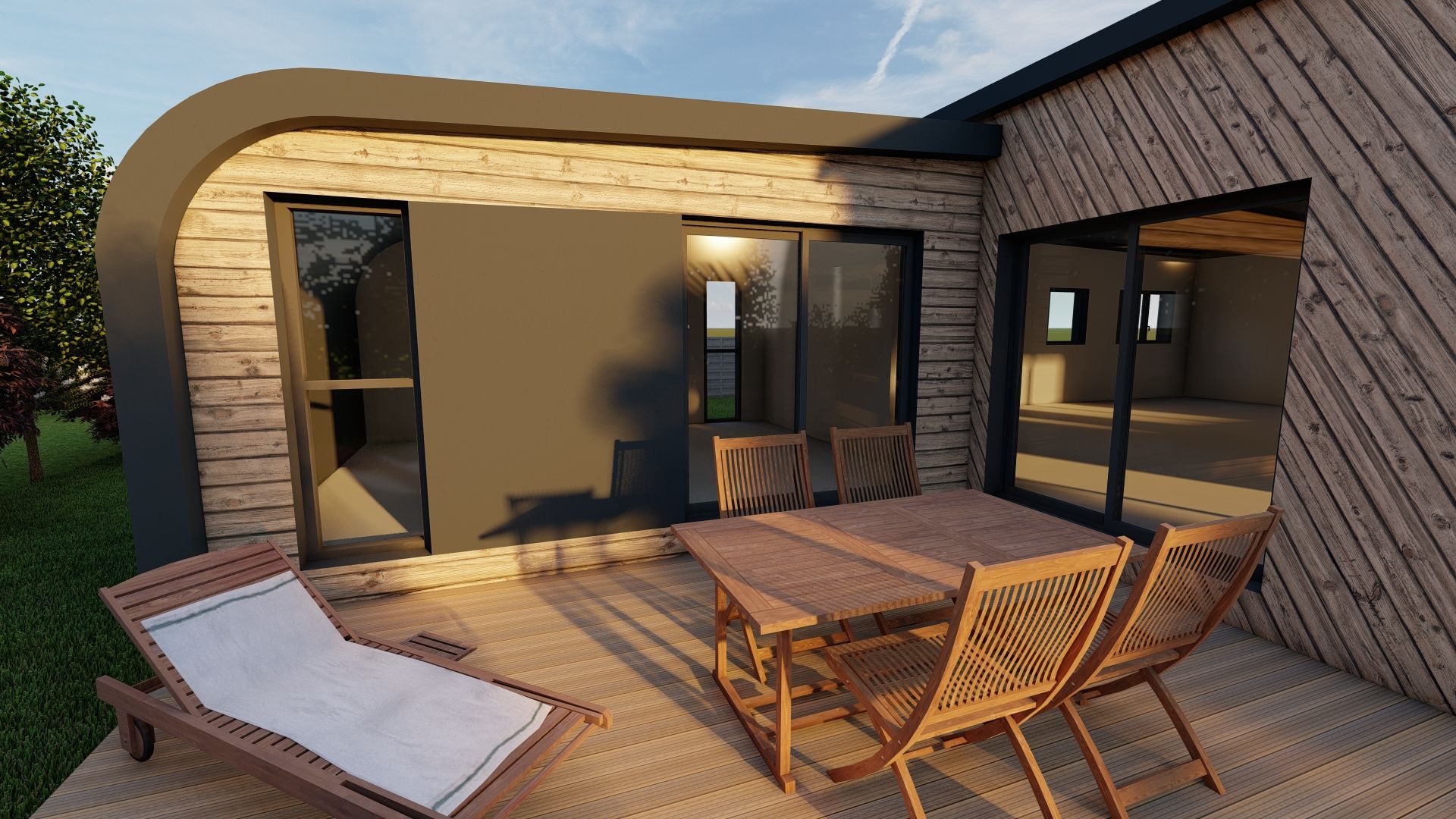 Patio avec des chaises en osier, une table et une chaise longue à l'extérieur d'une maison moderne en briques au coucher du soleil.