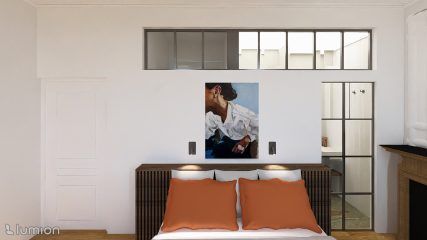 Chambre minimaliste avec des coussins orange, un tableau au-dessus du lit et une cloison vitrée.
