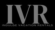 The logo for indulge vacation rentals is gray on a black background.