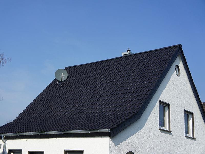 Ein weißes Haus mit einer Satellitenschüssel auf dem Dach