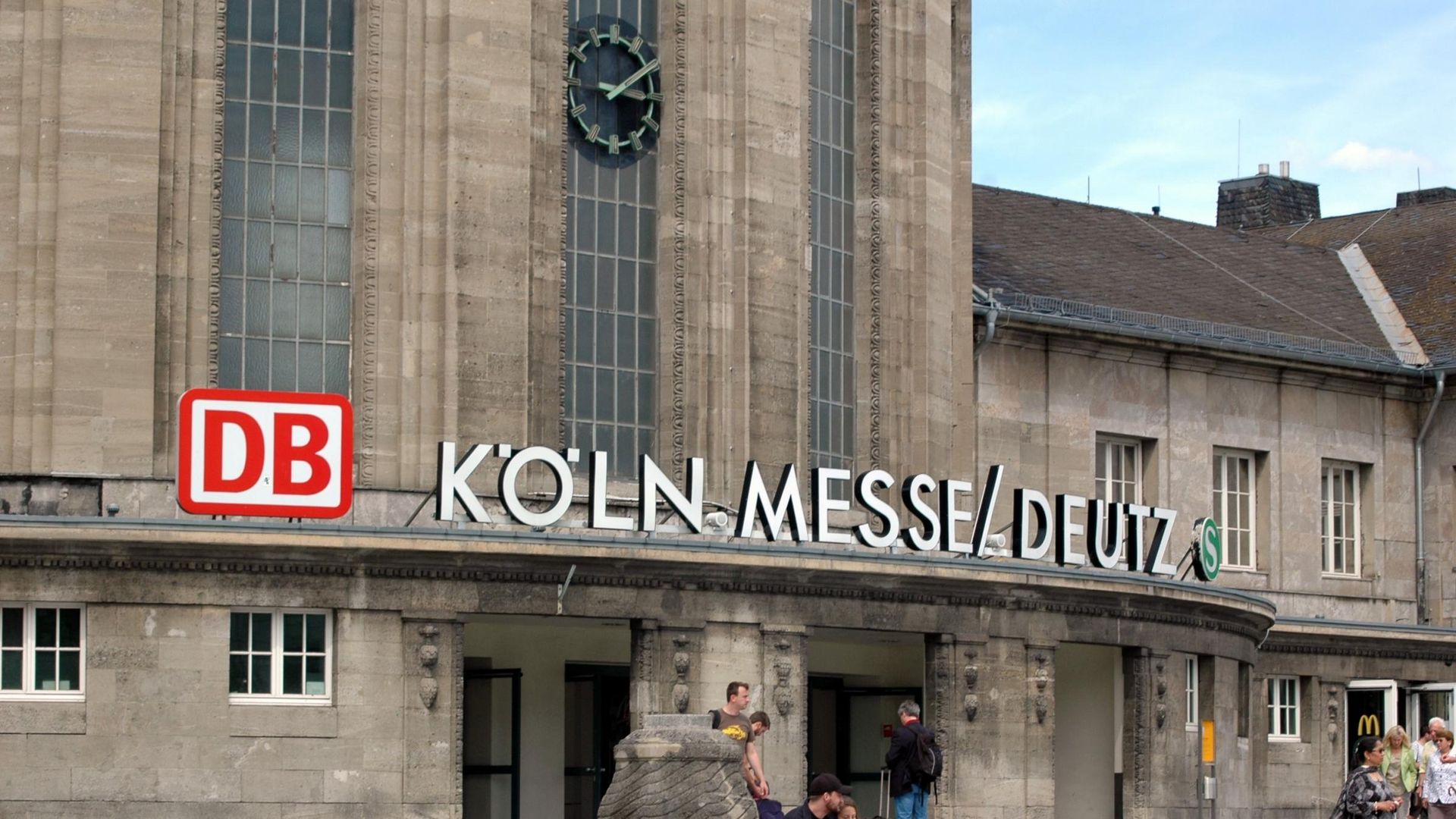 Cologne Messe/Deutz train station entrance with DB sign and clock on a stone building