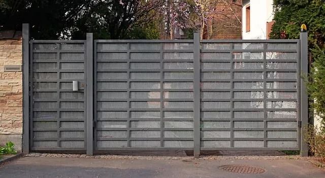 Una gran puerta de metal se encuentra frente a una casa.