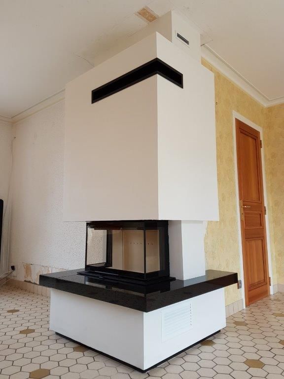 Grande cheminée de coin avec carrelage au sol