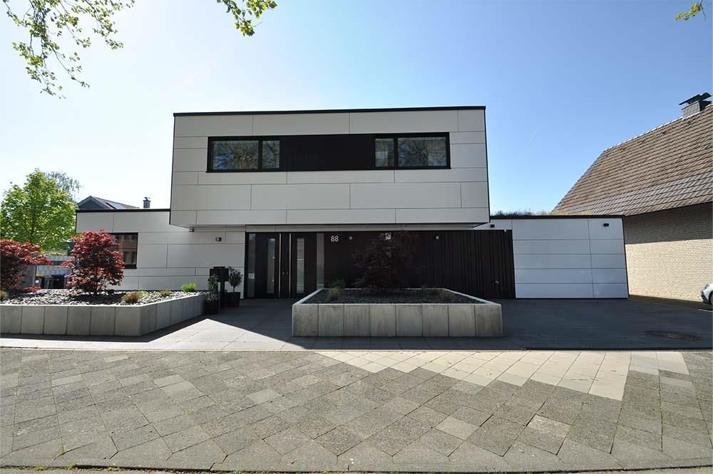 Ein weißes Haus mit einem schwarzen Streifen an der Seite