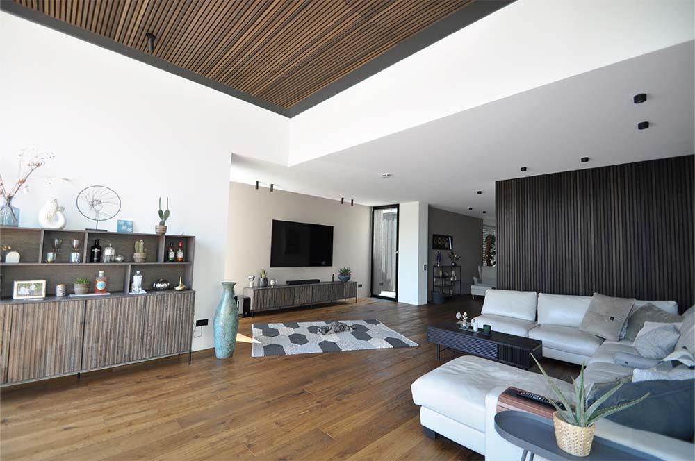 Ein Wohnzimmer mit einer Couch und einem Fernseher an der Wand.