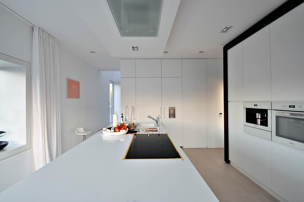 Eine Küche mit weißen Schränken und einem schwarzen Herd