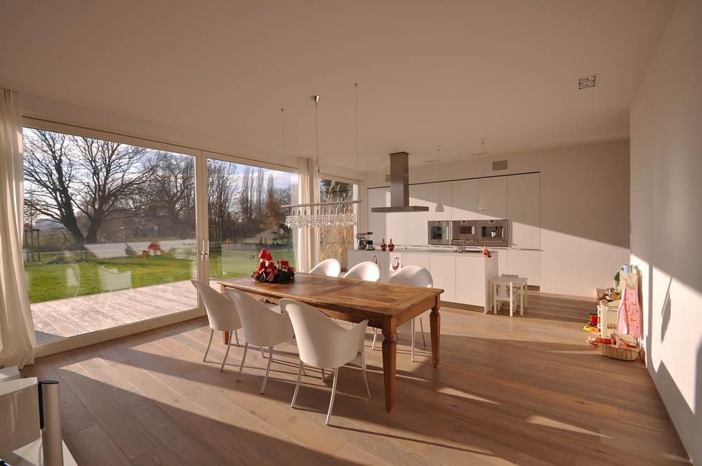 Ein Esszimmer mit Tisch und Stühlen und einem großen Fenster