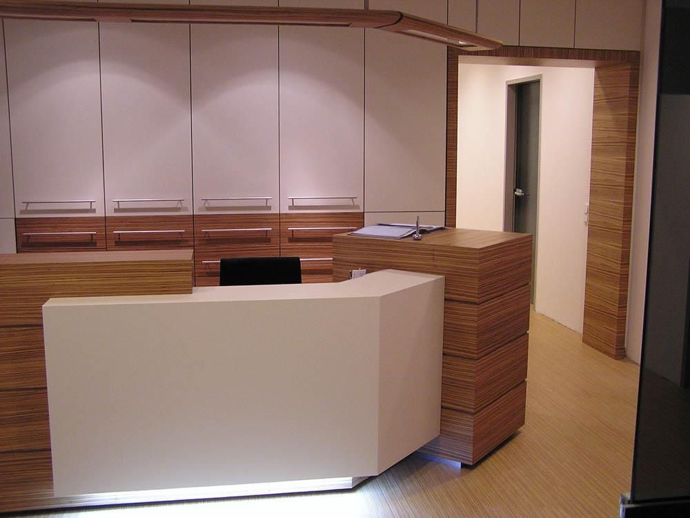 Eine weiße Theke in einem Raum mit Holzschränken