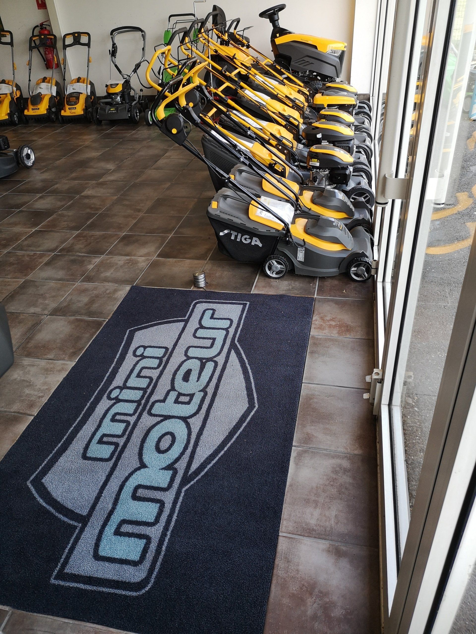 Tondeuses alignées devant une vitre