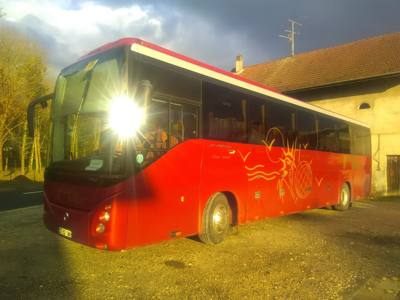 Autocar rouge garé avec soleil