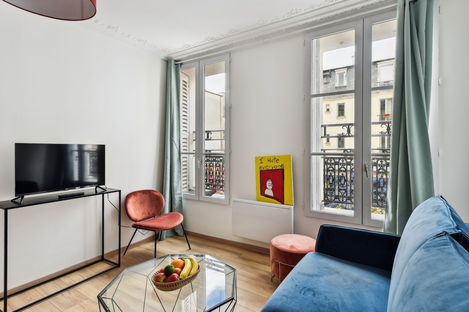 A living room with a couch , table , chair and television.