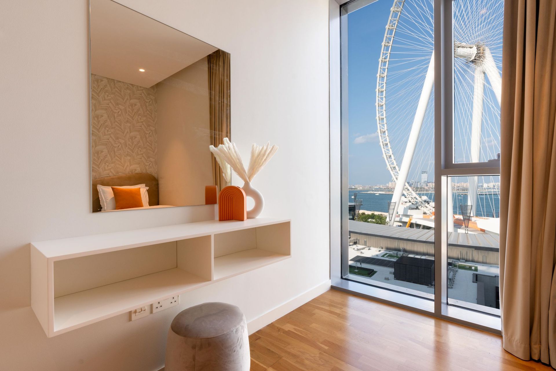 A bedroom with a ferris wheel in the background