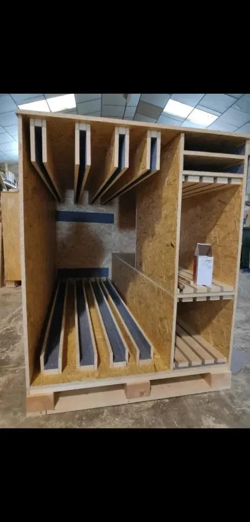 Caja de envío de madera con compartimentos internos, posiblemente para artículos frágiles.