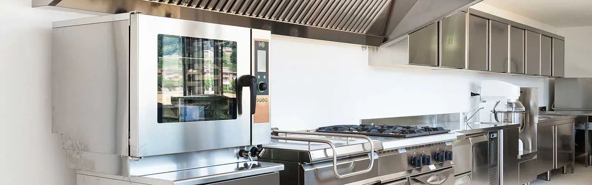 Una cocina con electrodomésticos de acero inoxidable y un horno grande.