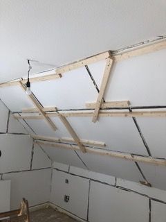 Von der Decke eines Zimmers hängt eine Lampe.