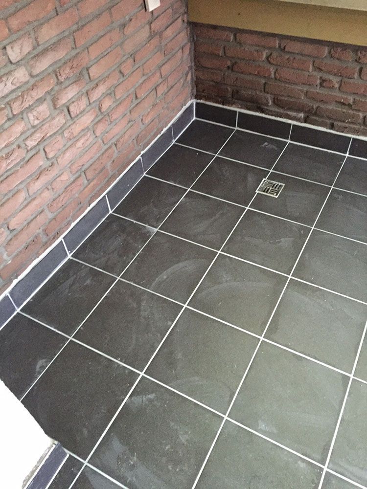 Ein gefliester Boden mit einer Ziegelwand im Hintergrund