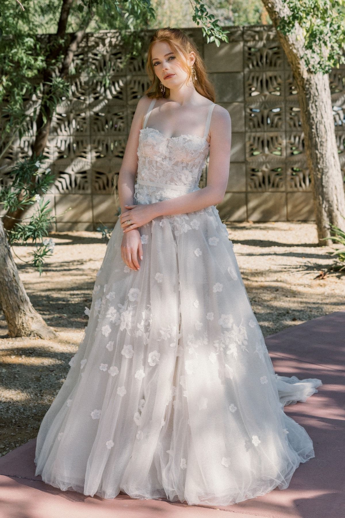 Eine Frau in einem Brautkleid steht in der Wüste.