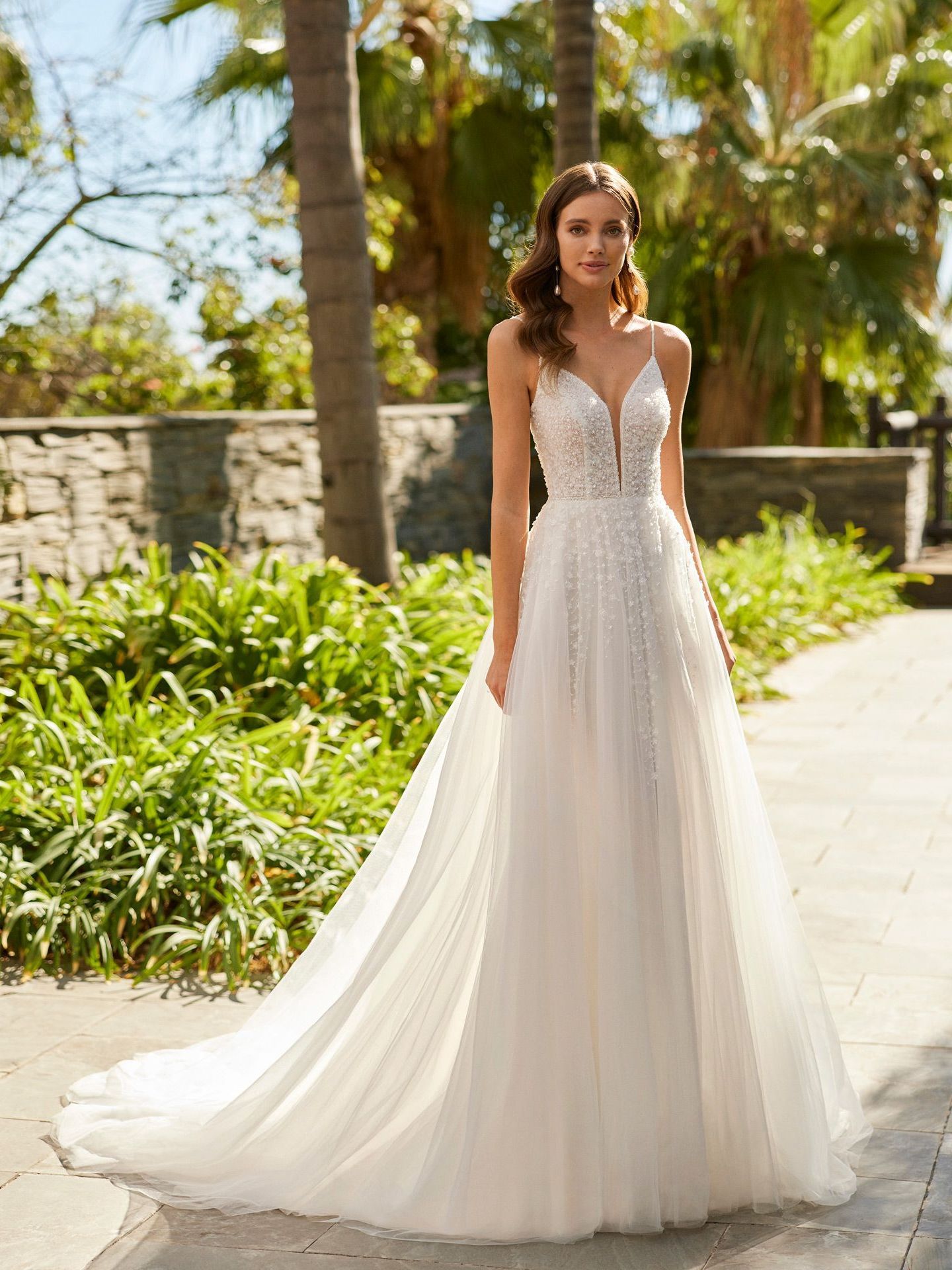 Eine Frau in einem weißen Brautkleid steht auf einem Bürgersteig.