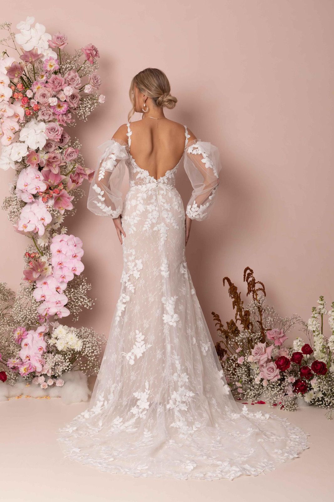 Eine Frau in einem Brautkleid steht in der Wüste.