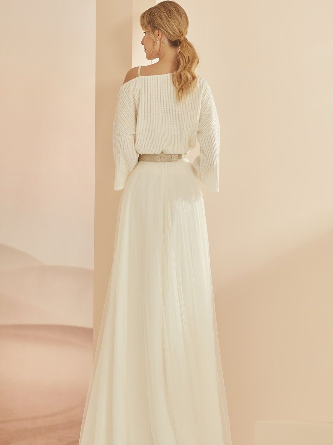 Der Rücken einer Frau in einem weißen Hochzeitskleid.
