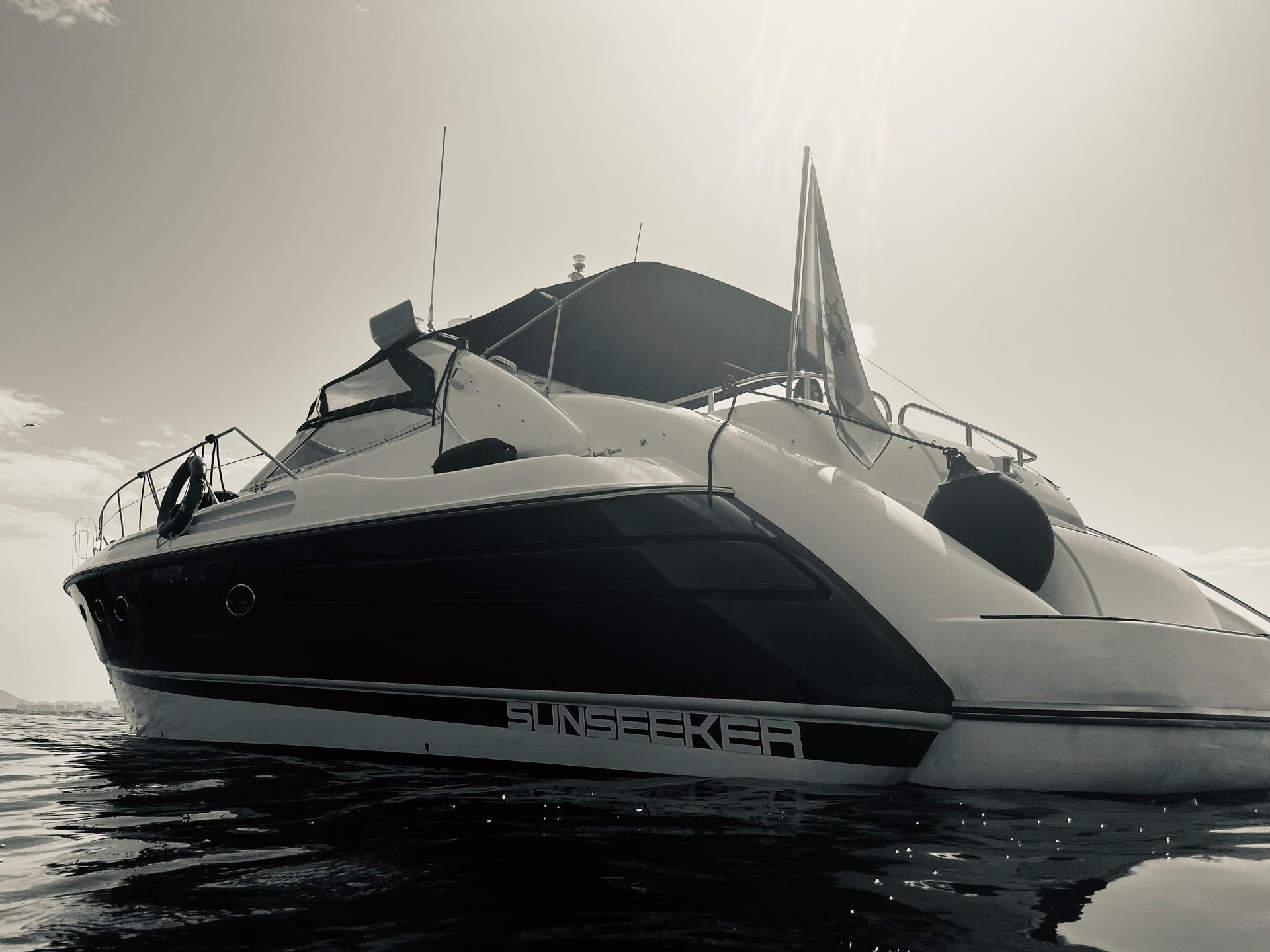 A black and white photo of a boat with the word porsche on the side