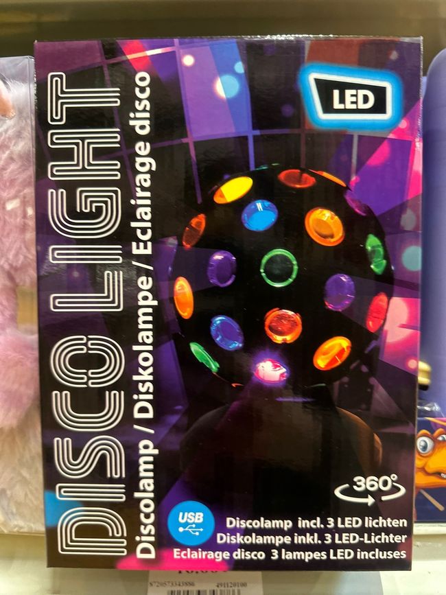 Boîte d'un éclairage disco à LED avec effets lumineux rotatifs colorés et inscription Disco Light sur l'emballage.