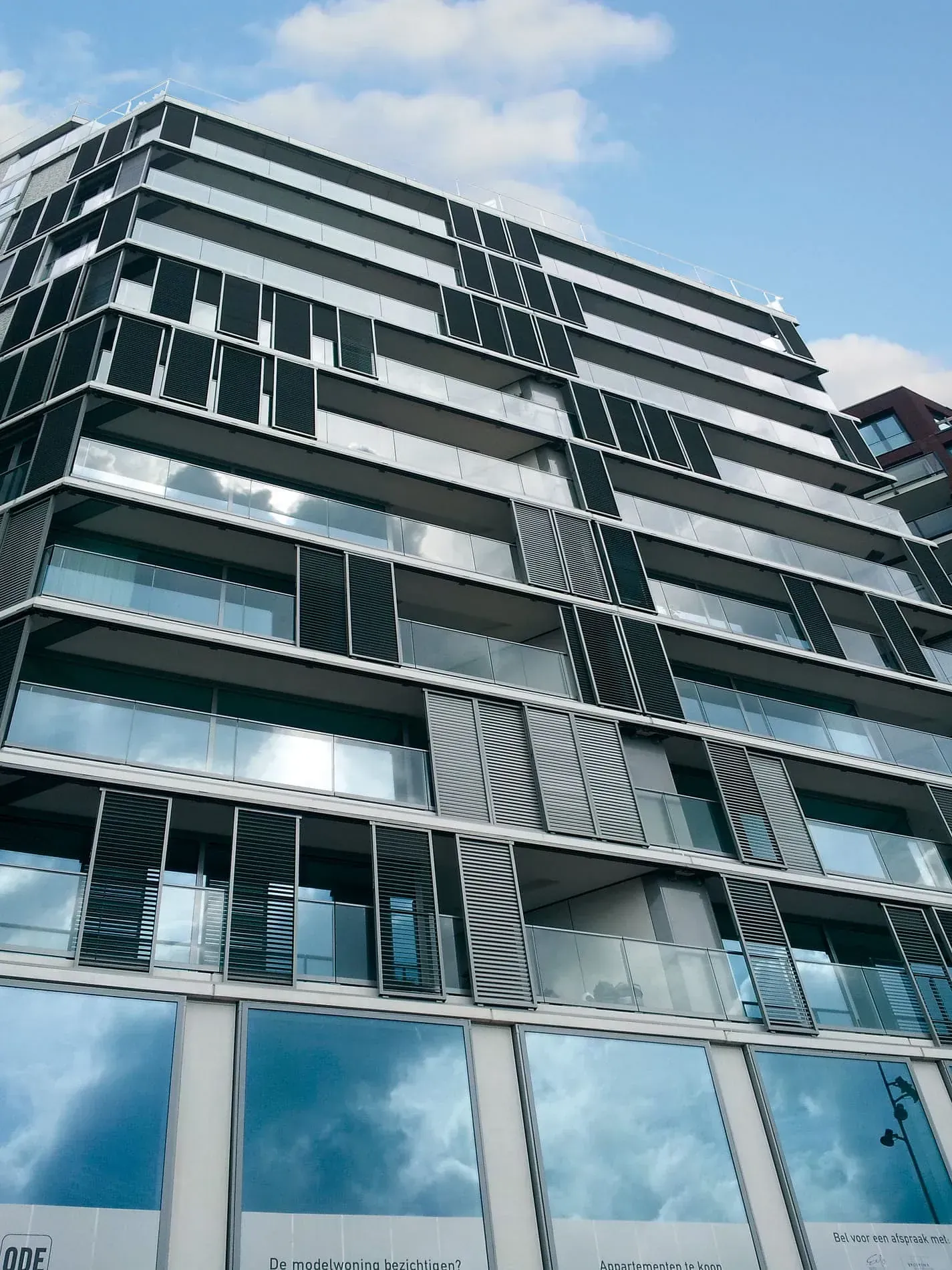 Un edificio alto con muchas ventanas y balcones.