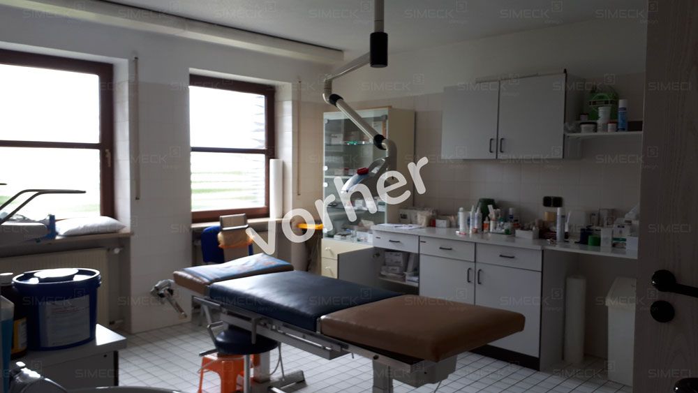 Ein leerer Operationssaal mit einem Bett und einem Fenster.